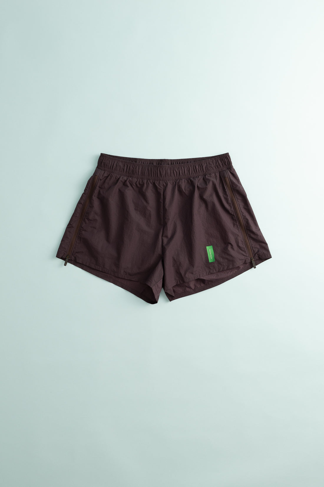 District Vision Women's Ultralight Nylon Zippered Shorts in Nightshade, featuring a lightweight design and side zippers.