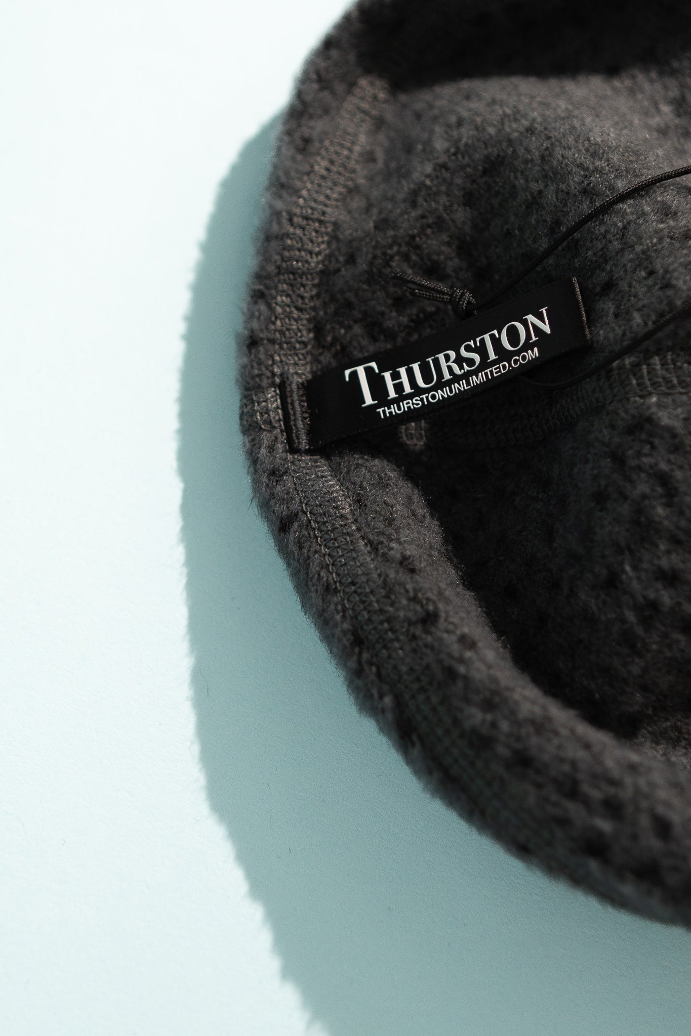 High Loft Wool Beanie label inside a cozy anthracite hat on a light background.