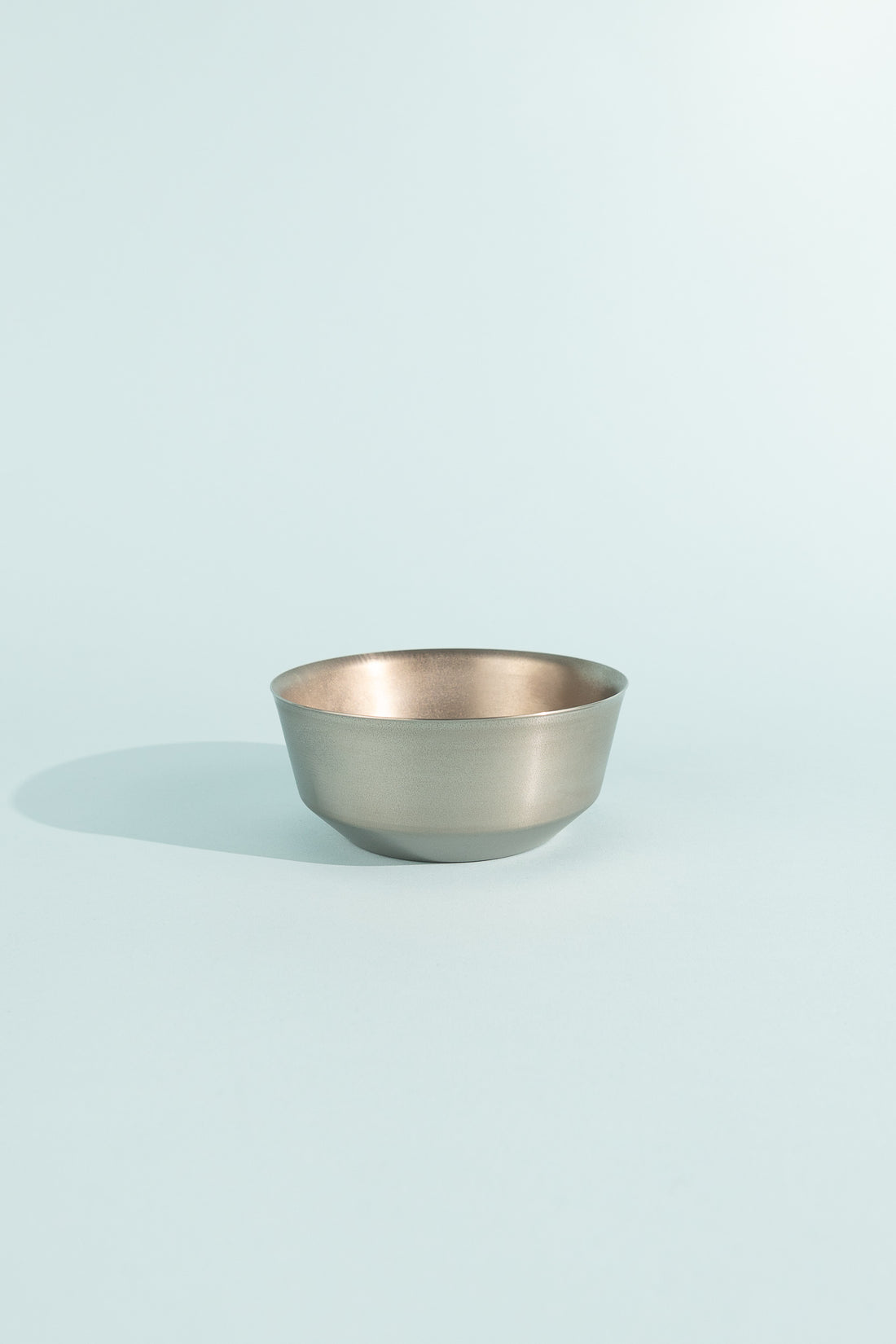Titanium Double Wall Bowl 600 displayed against a light blue background, showcasing its sleek design.