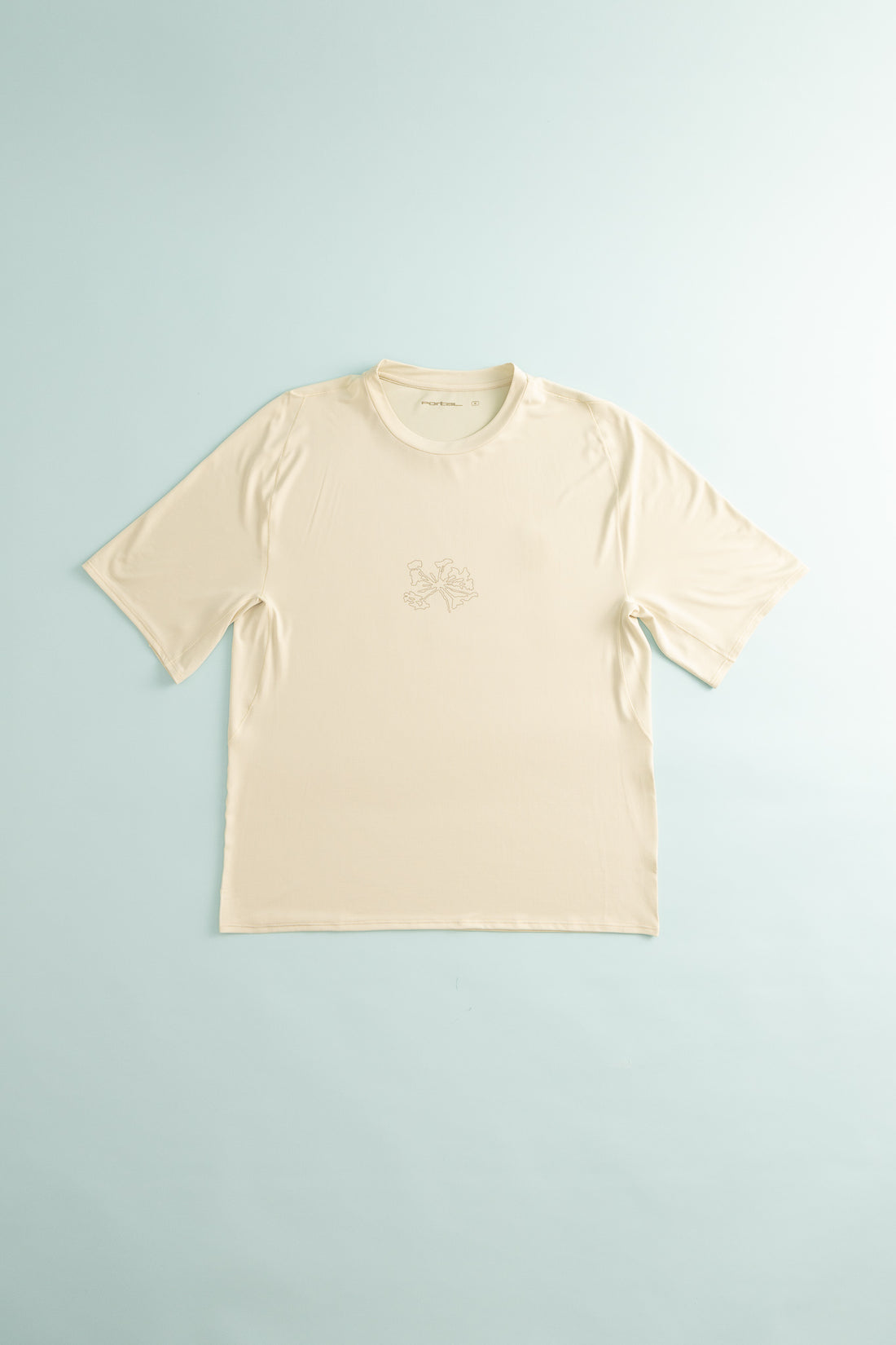 Lateral Peak Tee in light beige color, featuring ergonomic design for hiking and running activities.
