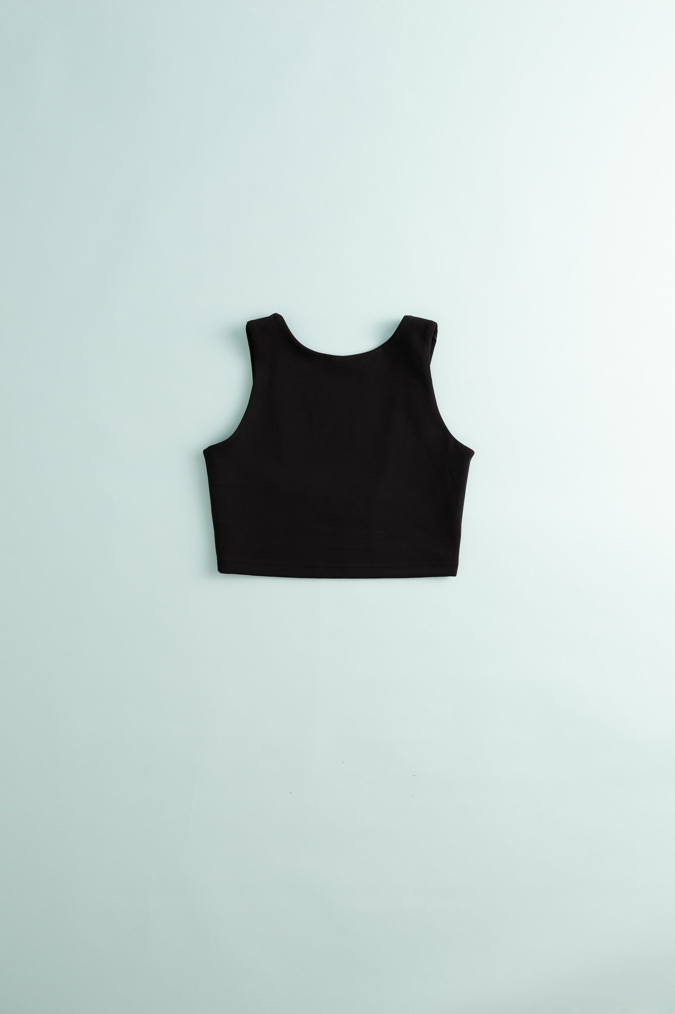 District Vision Womens High Neck Interlock Bra - Black on a light background, showcasing its sleek design.