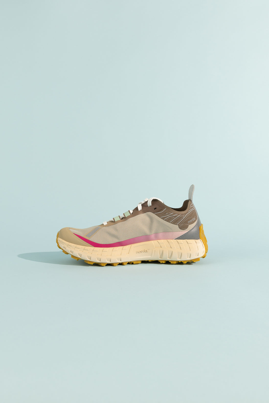 001A - Sky sneaker showcasing grey and pink design with durable sole on a light blue background.