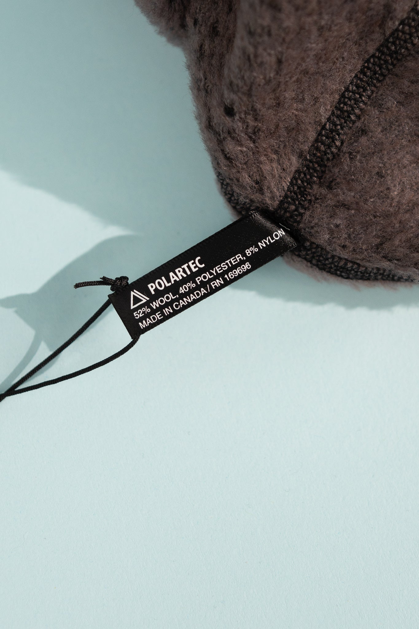 High Loft Wool Beanie care label showing materials and manufacture details.