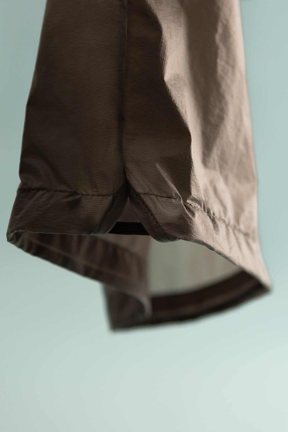 Close-up of the Breaker Wind Pant - Iron, showcasing the hem and lightweight nylon material.
