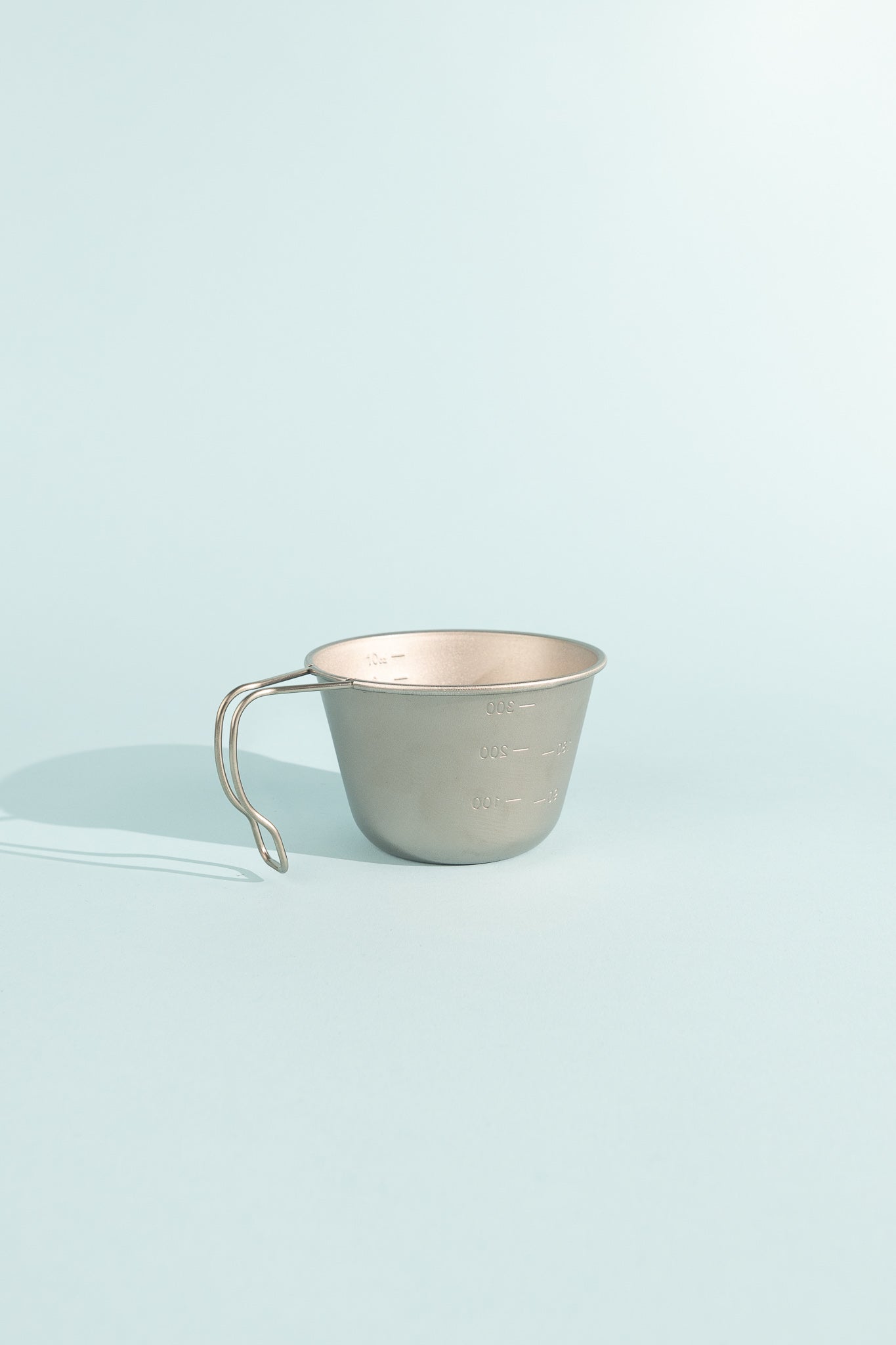 Deep Titanium Backpacker's Cup with Lid showing graduated measurement lines and sturdy handle.