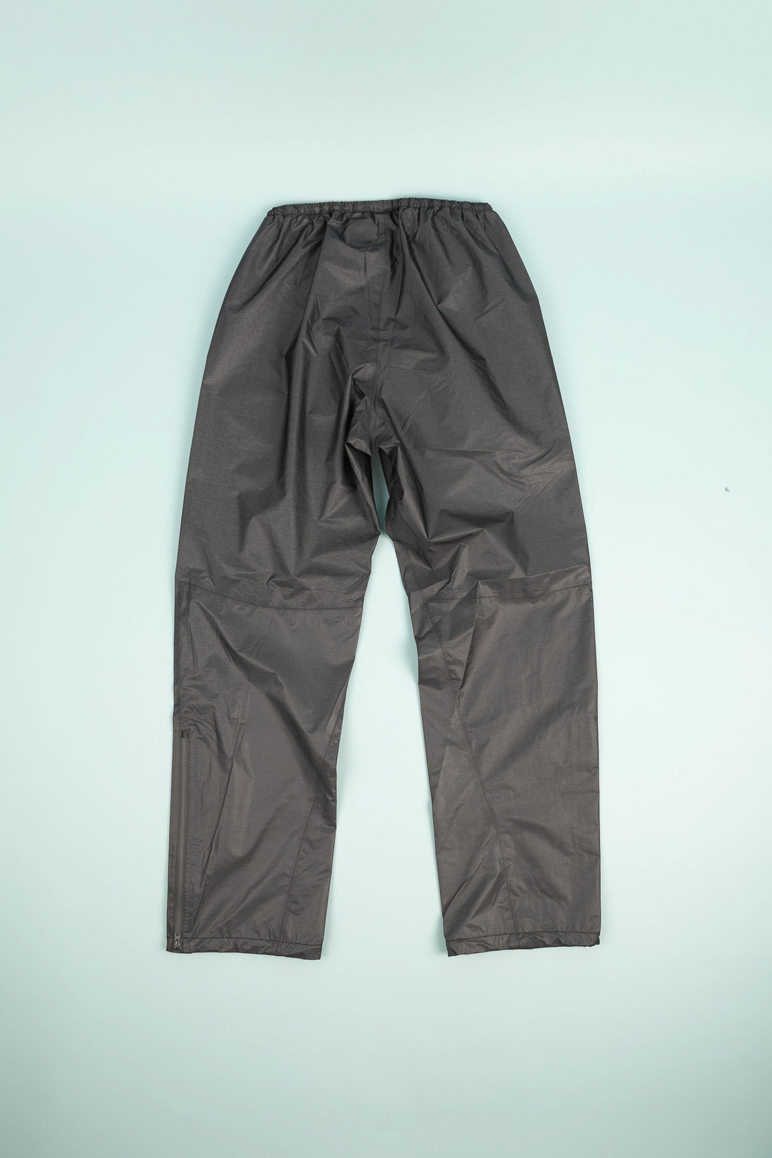 Montbell US Women's Dry-Tec U.L. Rain Pants in dark gray, showcasing ultralight fabric perfect for wet conditions.