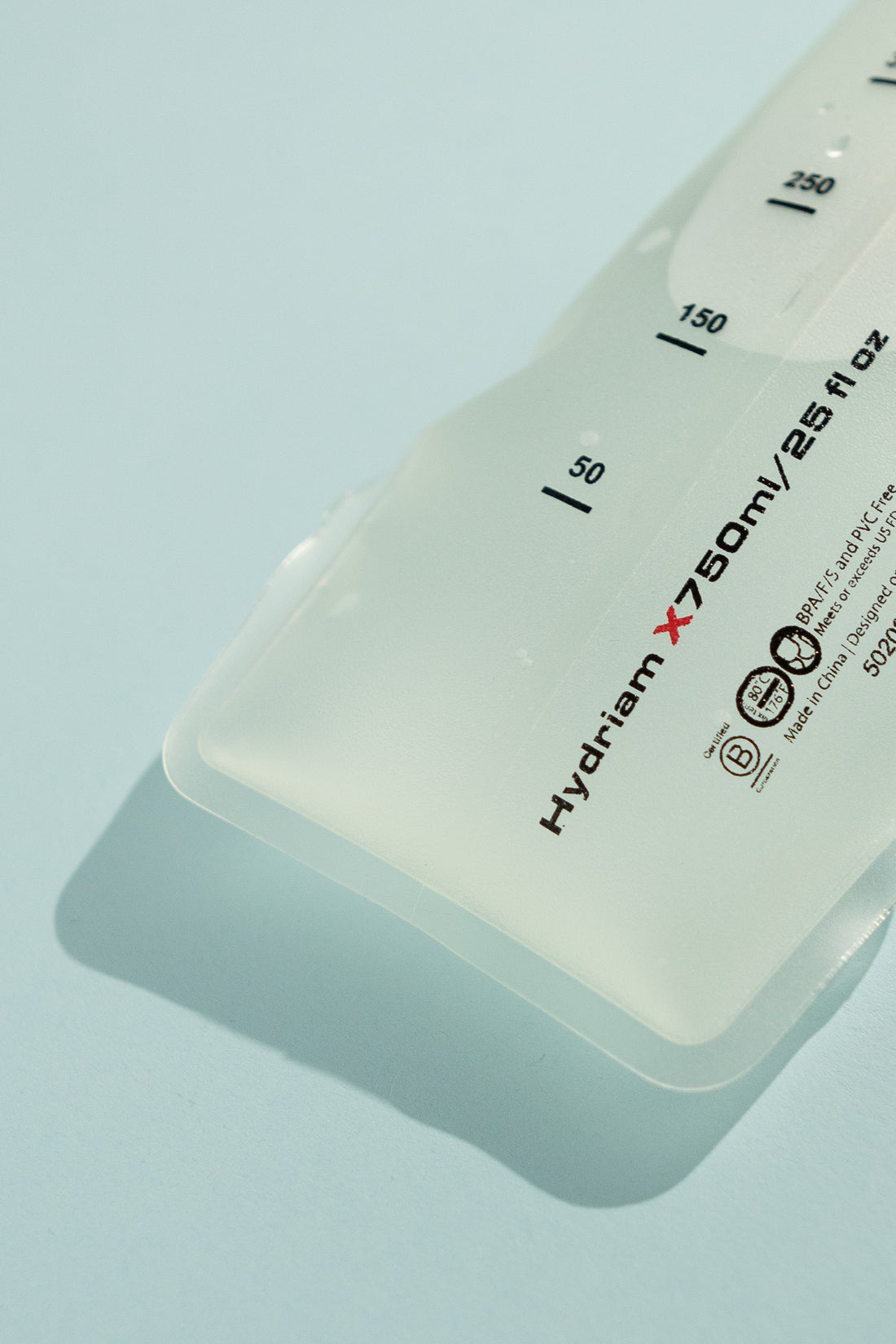 HydriamX 750ml collapsible flask showing measurement markings on a light blue background.