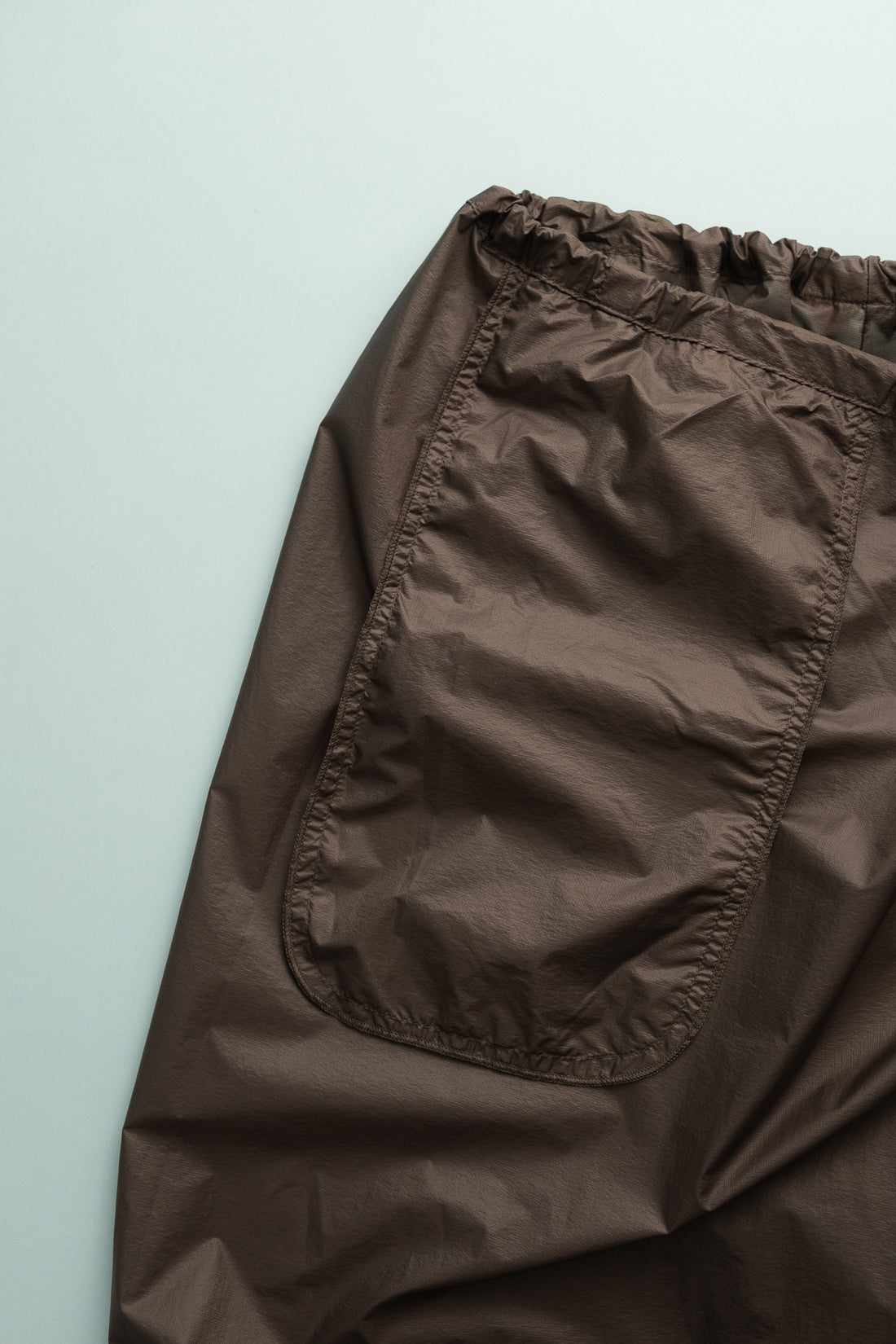 Close-up of Gnuhr Breaker Wind Pant in Iron color, showcasing a lightweight fabric and elastic waistband.