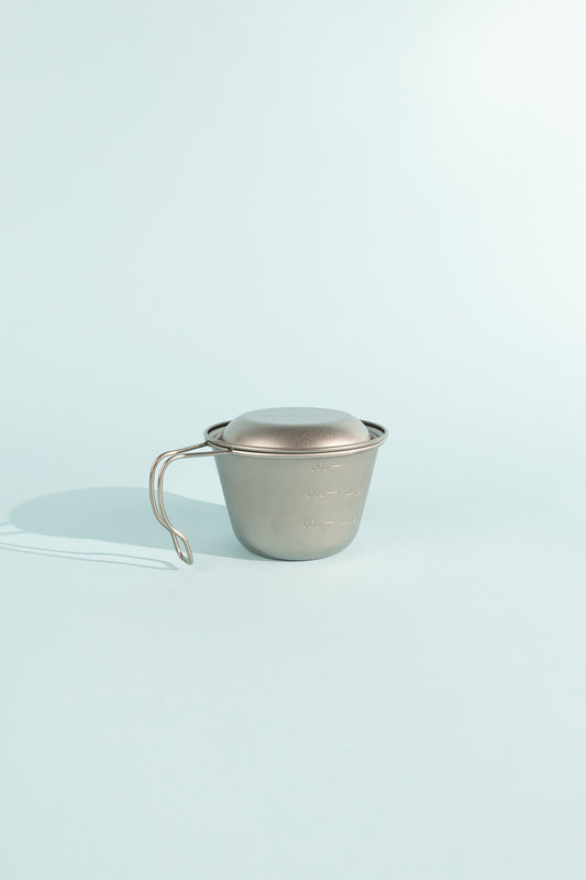 Deep Titanium Backpacker's Cup with Lid, durable design ideal for cooking and measuring, featuring a sturdy handle.