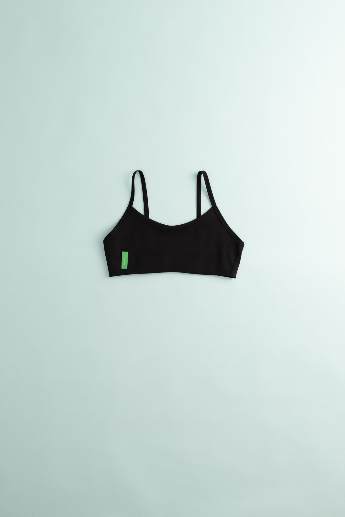 District Vision Women's Light Support Interlock Bra in black on a light background.