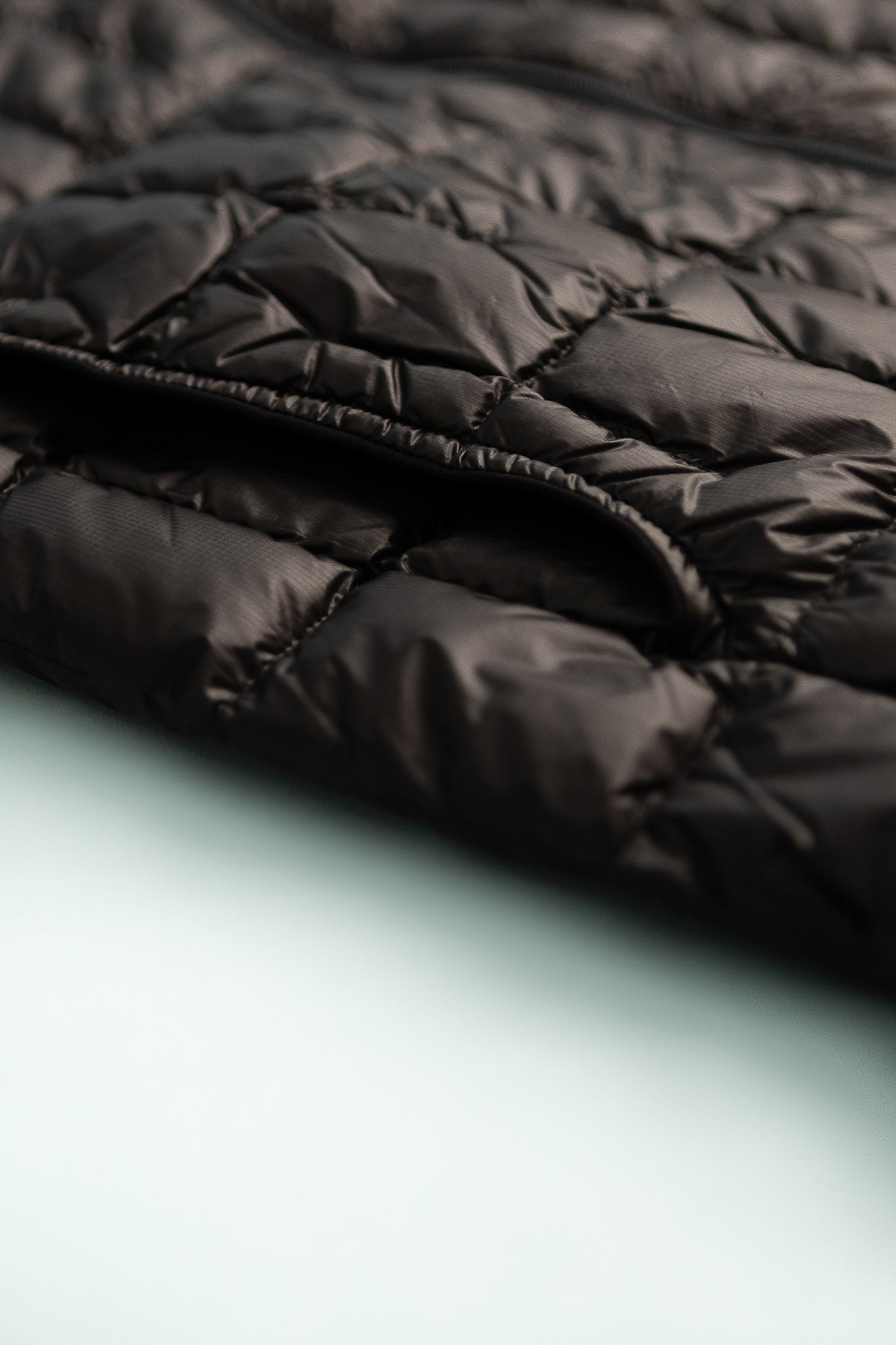 US Mens Plasma 1000 Down Jacket detail showing lightweight black fabric and quilted design.