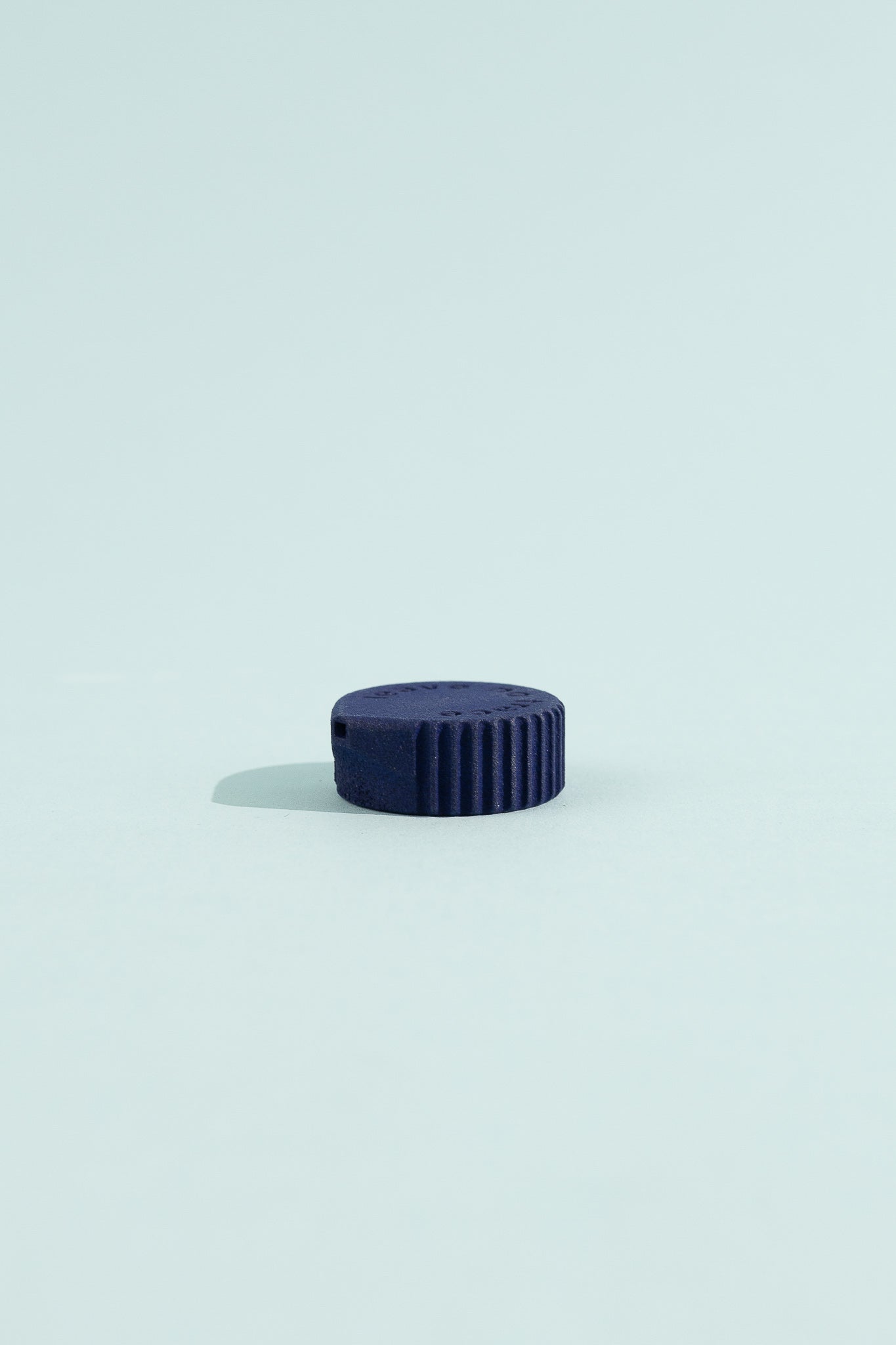Igneous Gear Bottle Cap Bidet - Azurite on a light blue background, showcasing its compact design for hygiene on the go.