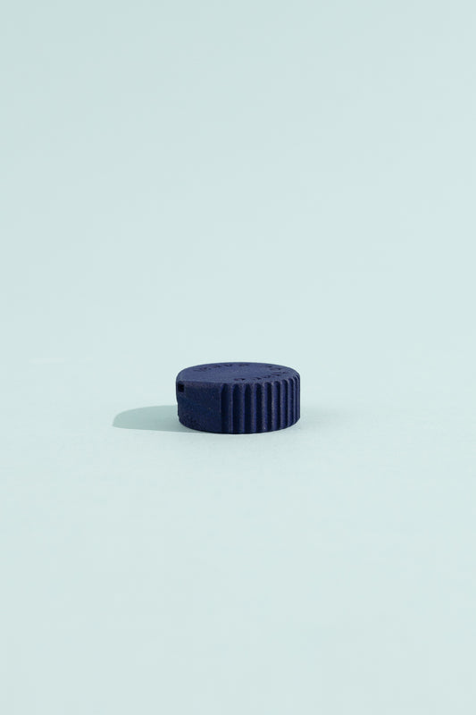 Igneous Gear Bottle Cap Bidet - Azurite on a light blue background, showcasing its compact design for hygiene on the go.