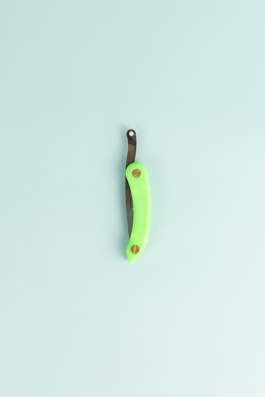 Peasant Knife Mini - Green on a light blue background, showcasing its handcrafted design and vibrant handle.