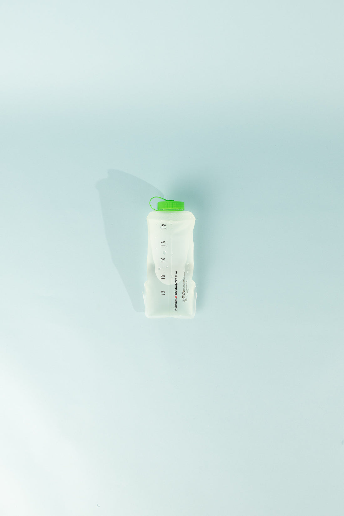 HydriamX 500ml Collapsible Flask displayed on a light blue background, showcasing its soft and durable design.
