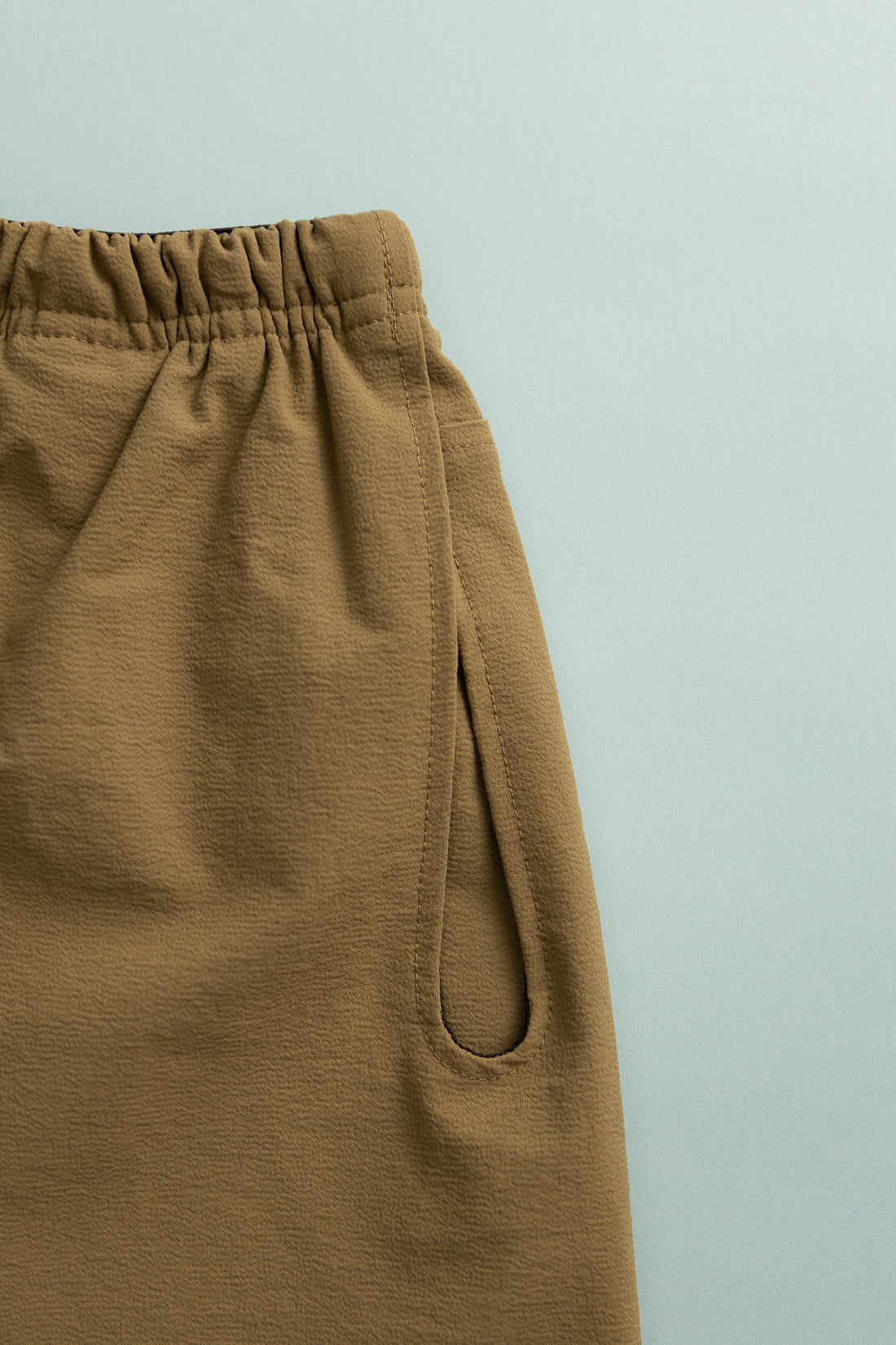 Close-up of Gnuhr Explora Short in khaki with a unique loop pocket detail.