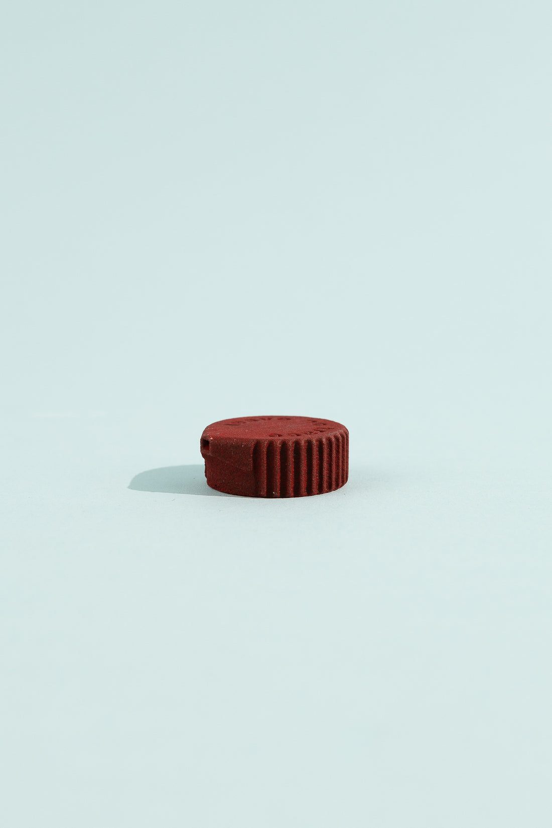 Bottle Cap Bidet - Magnetite, compact red attachment for hygienic bidet transformation of water bottles.