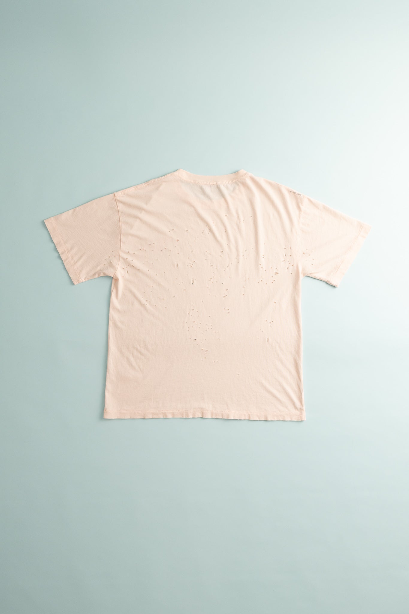 Back view of MothTech™ T-Shirt in sun bleached rosewater with ventilation holes for cooling.