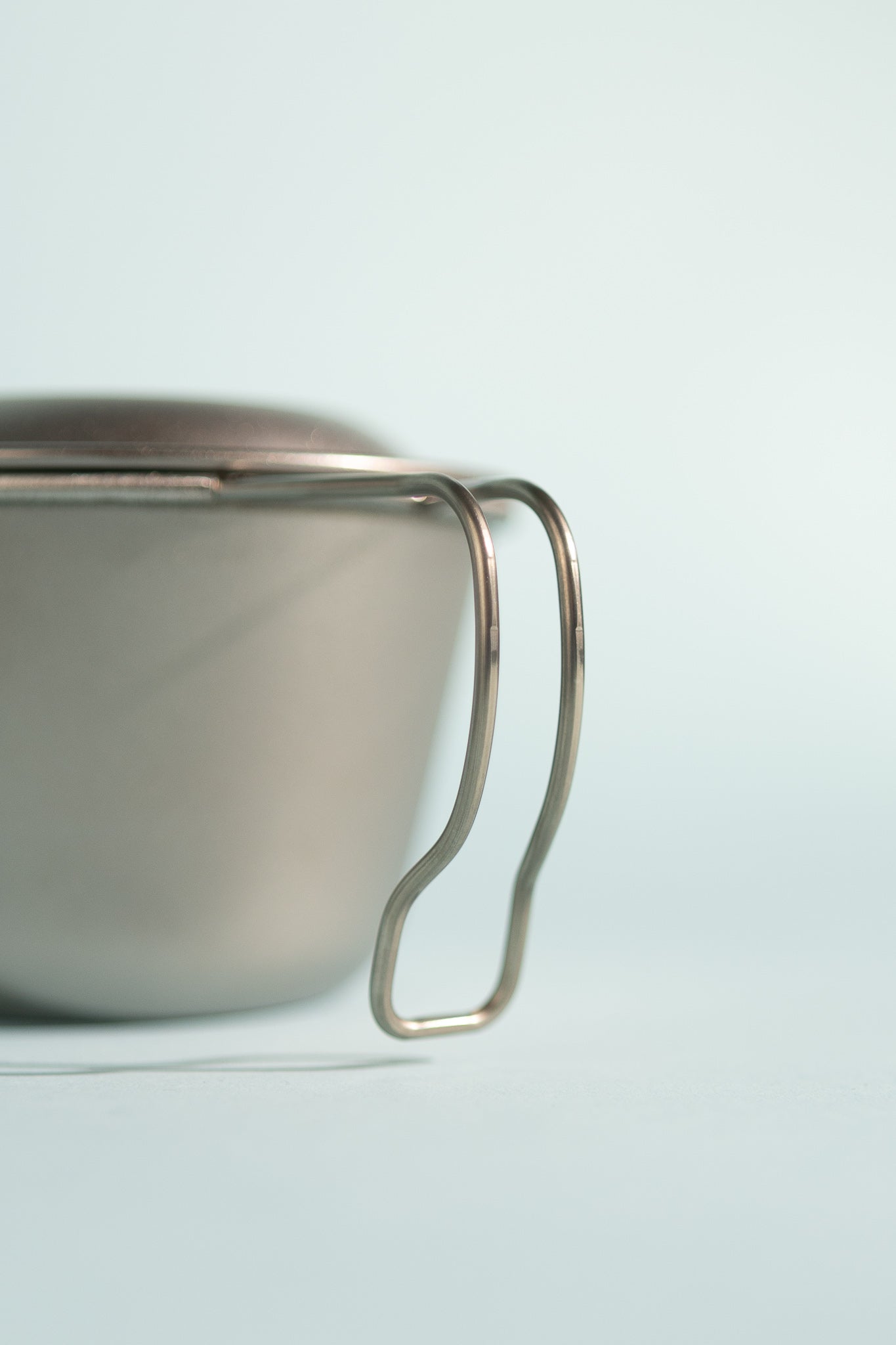 Deep Titanium Backpacker's Cup with lid featuring a sturdy handle for easy use.