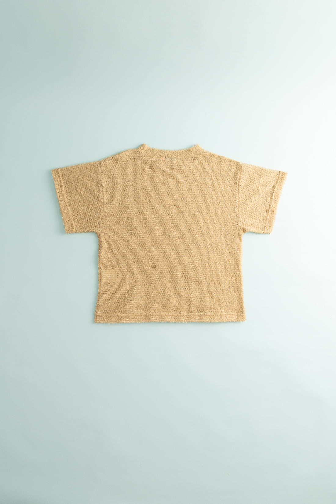 Back view of the Shag Tee v2.0 in Cornstalk color, showcasing its lightweight and shaggy texture.