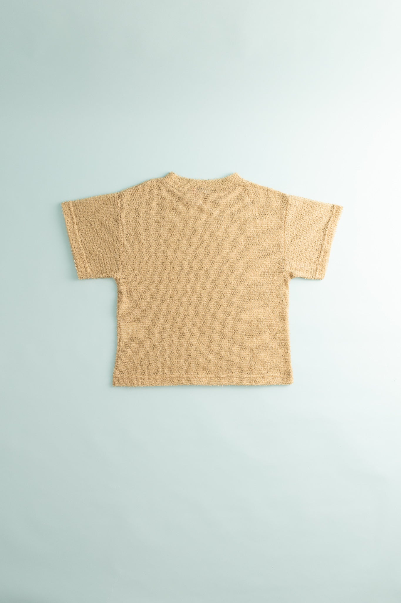 Back view of the Shag Tee v2.0 in Cornstalk color, showcasing its lightweight and shaggy texture.