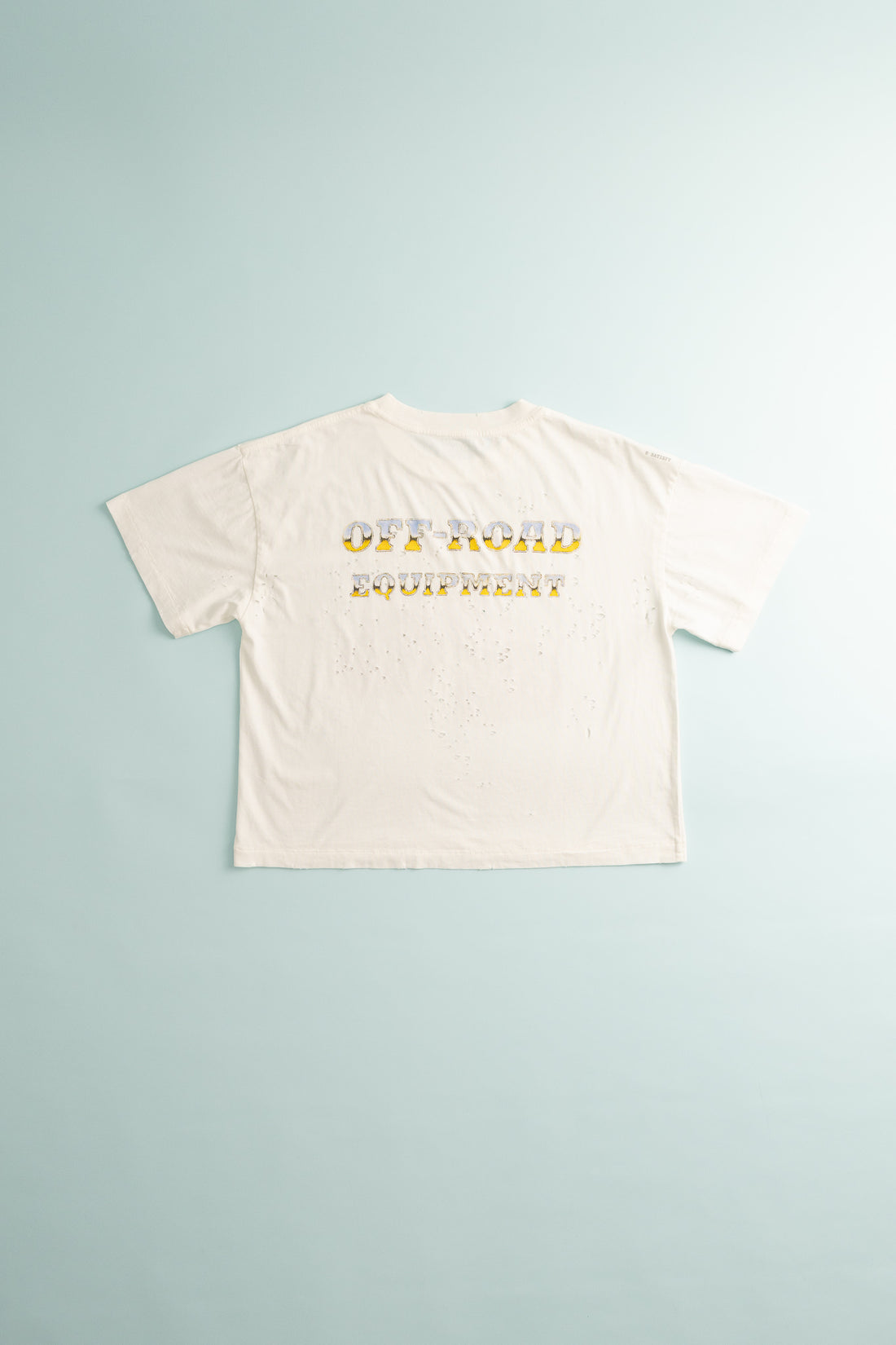 Women's MothTech™ T-Shirt in off-white with monster truck design on the back, showcasing ventilation features.