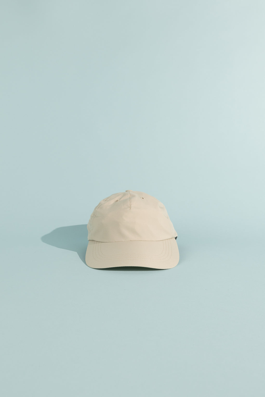 C9 Cap - Foggy Mountain on a light blue background, showcasing its ultralight and breathable design.