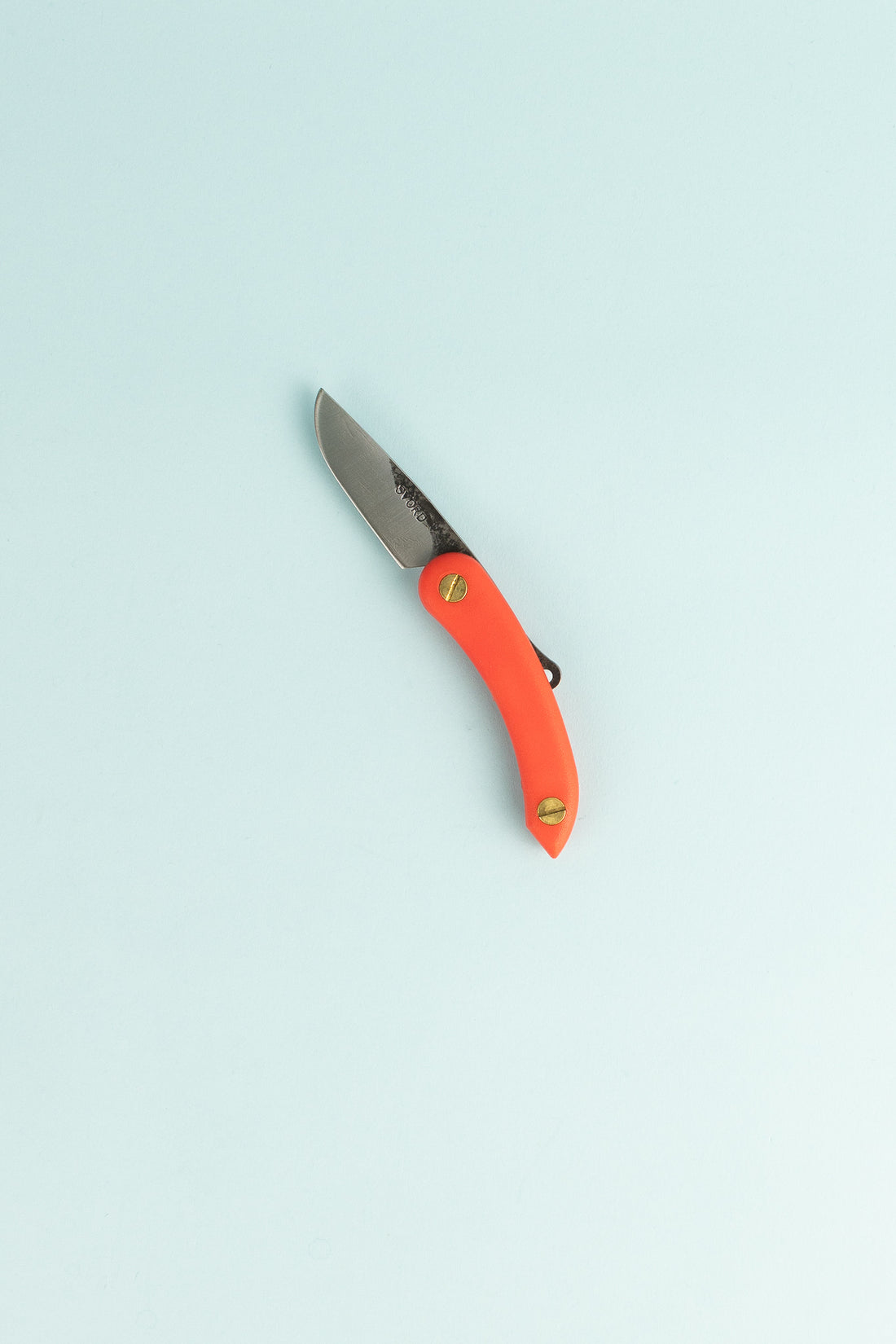 Peasant Knife Mini - Red with a high grade carbon blade and an orange handle on a light blue background.