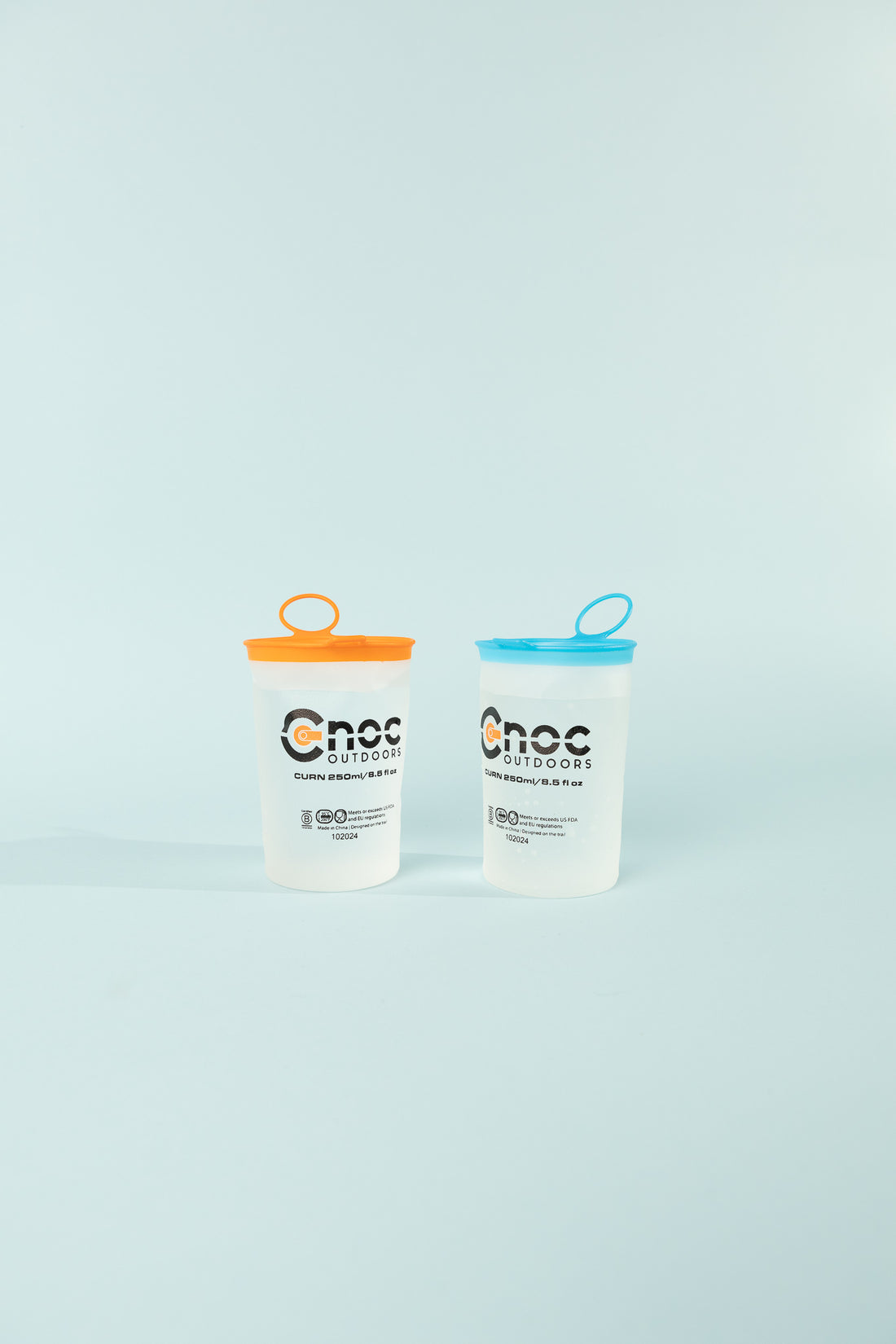 Curn Ultralight Cups Pair 250ml in orange and blue with collapsible design and logo.
