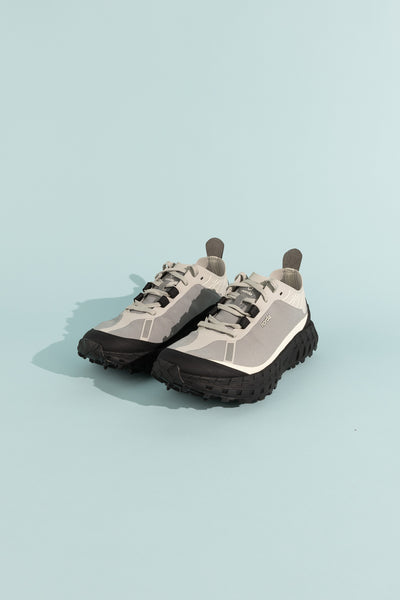 001A - Pewter shoes displayed on a light blue background showcasing unique design and features.