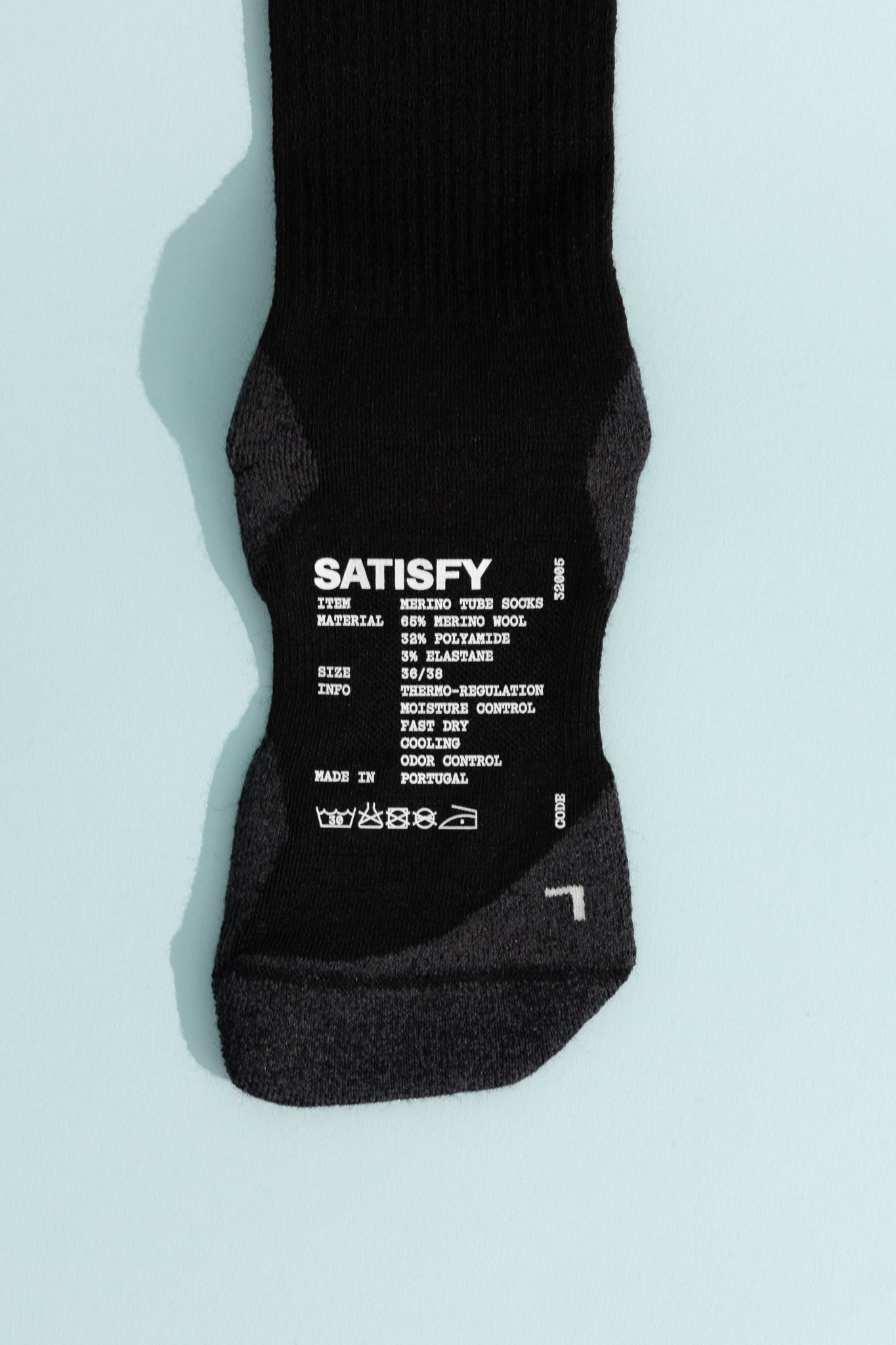 Merino Nylon Tube Socks showing Satisfy brand label and material details on the sole.