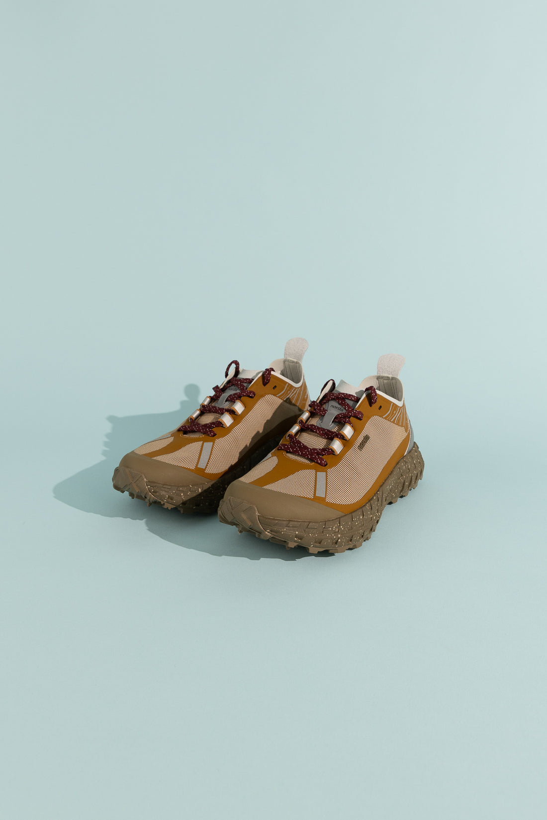 001A - Loam shoes featuring Arnitel® TPEE® midsole technology on a light blue background.